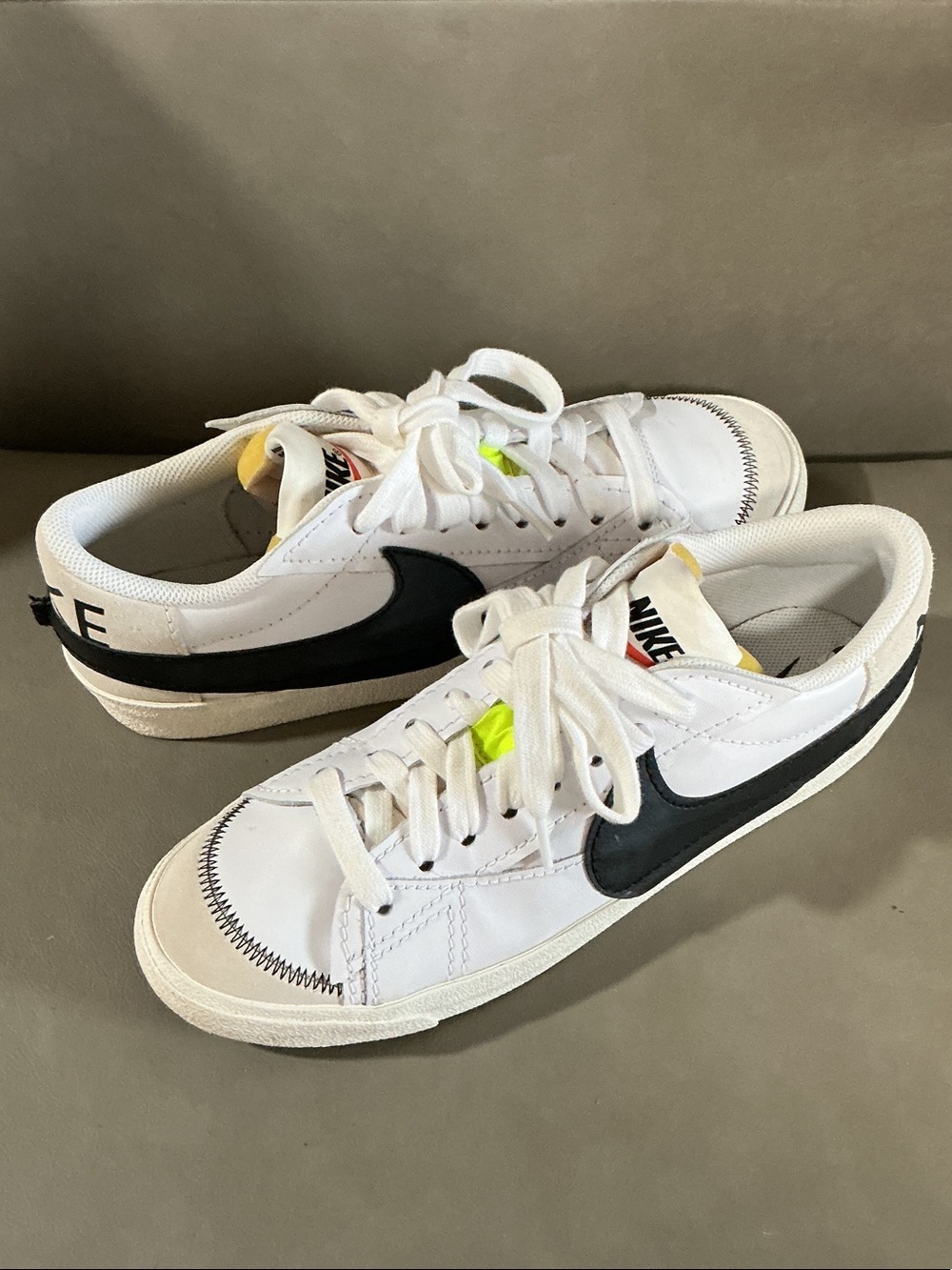 Nike White Low-Top Sneakers with Black Swoosh and Neon Yellow Accents